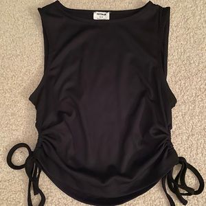 Black crop tank with side that tie in an open loop